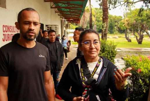 Un hombre y una mujer caminan por un pasillo.